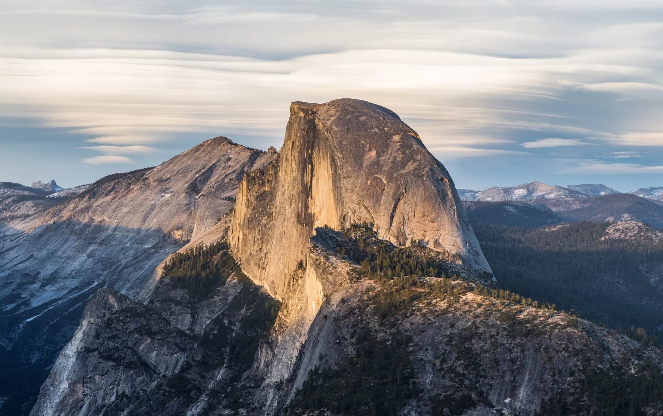 Half Dome lit by golden-hour sun above Yosemite Valley.