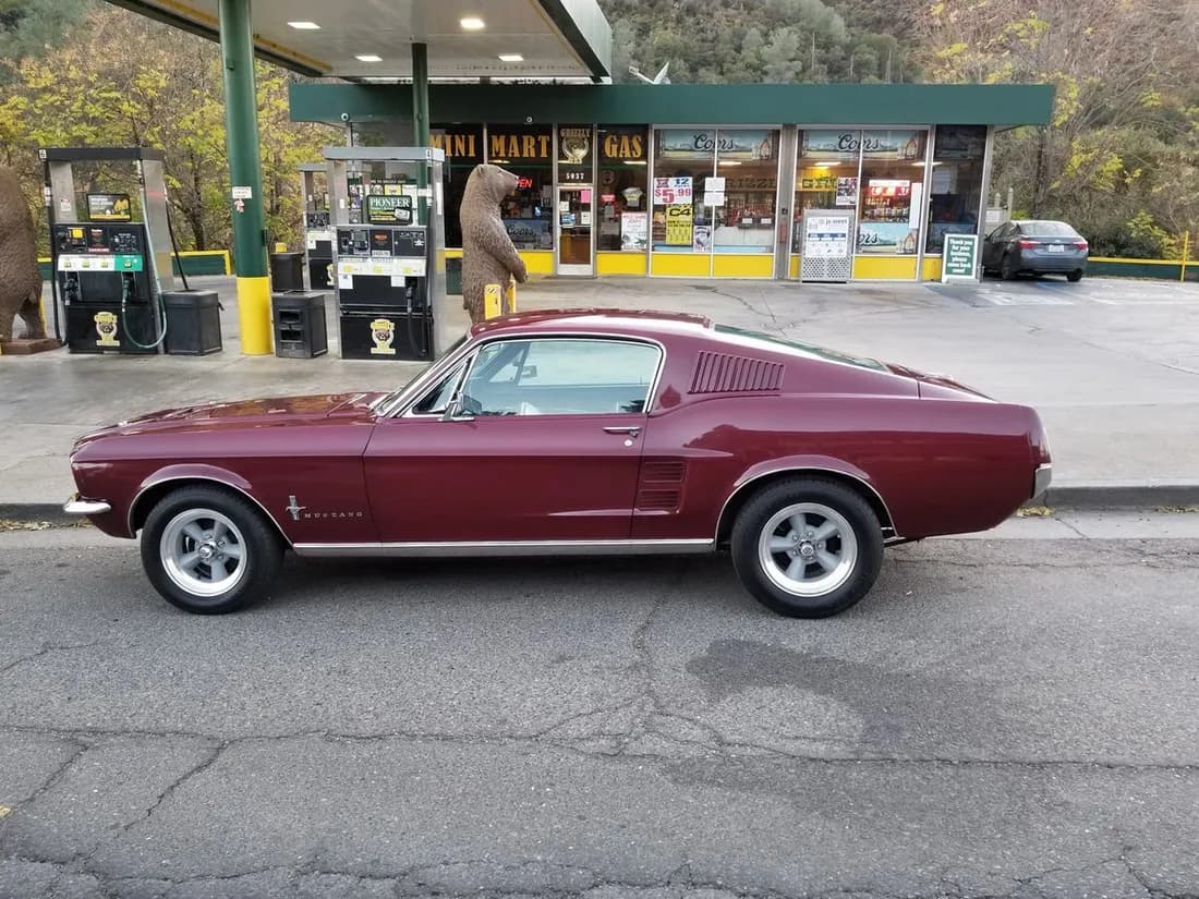 Classic Ford Mustang parked along a row of historic Main Street storefronts.